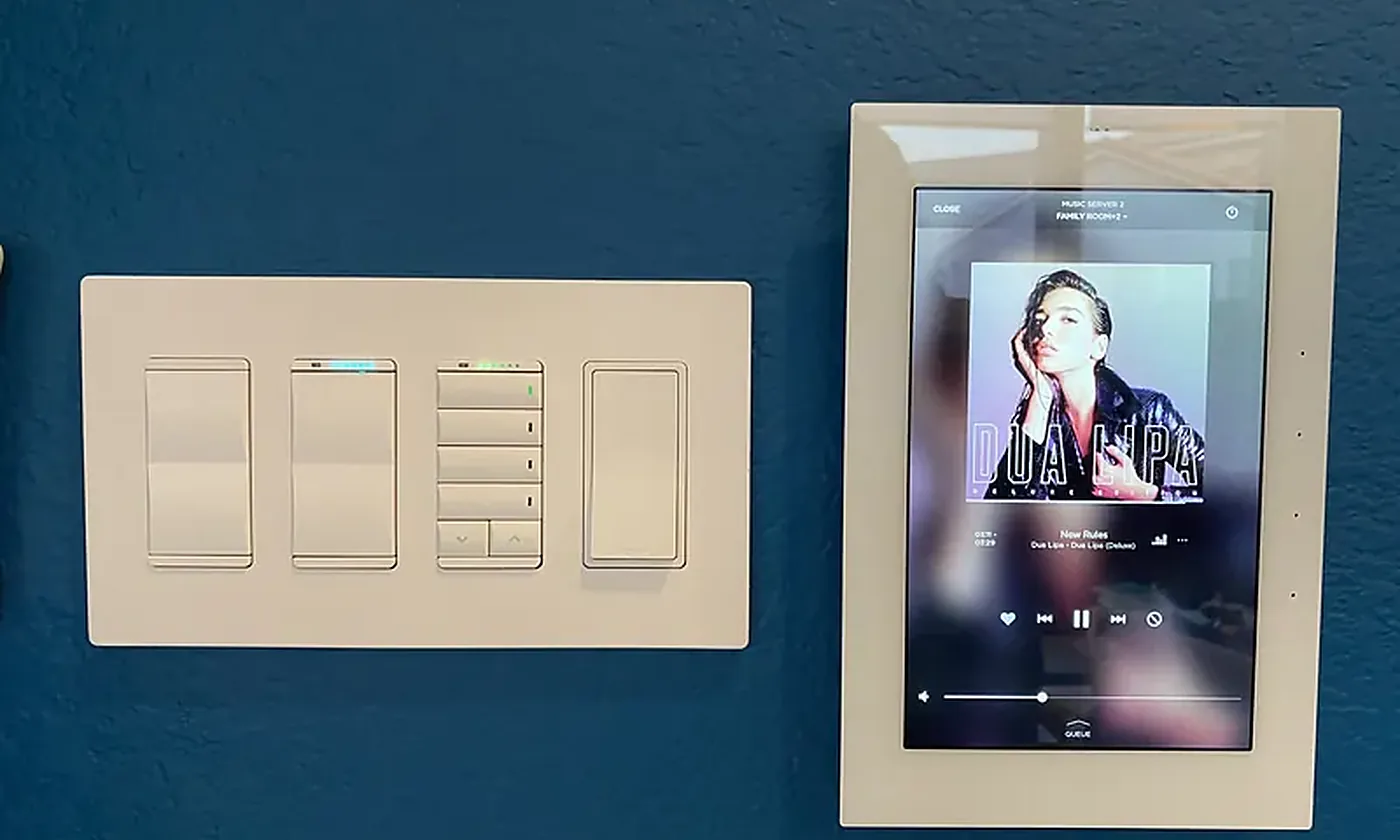 Savant keypad and touch panel on a navy wall, a WH Technologies installation