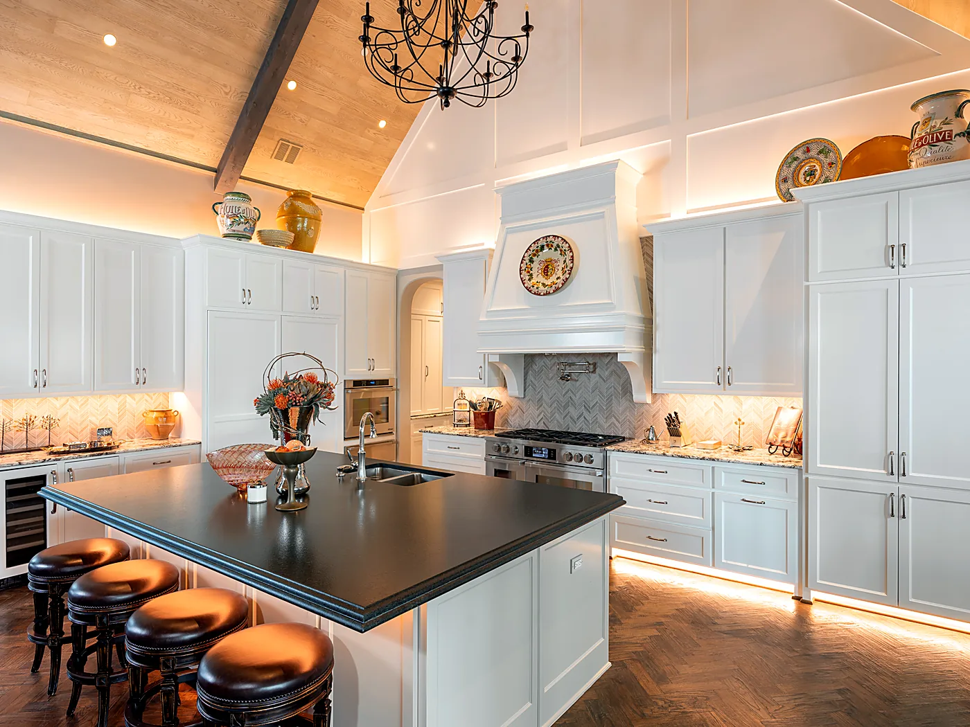 White kitchen with lit cabinet interiors and under-counter lighting