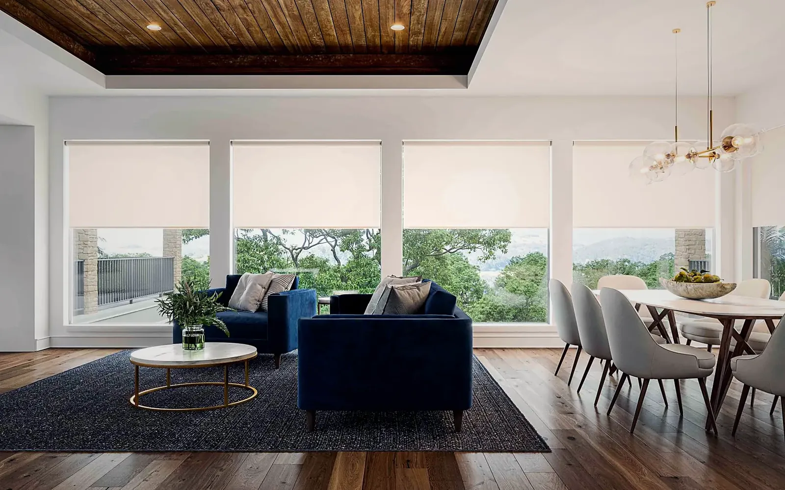 Living and dining room with floor-to-ceiling windows and solar shades lowered, the trees outside still visible through the fabric