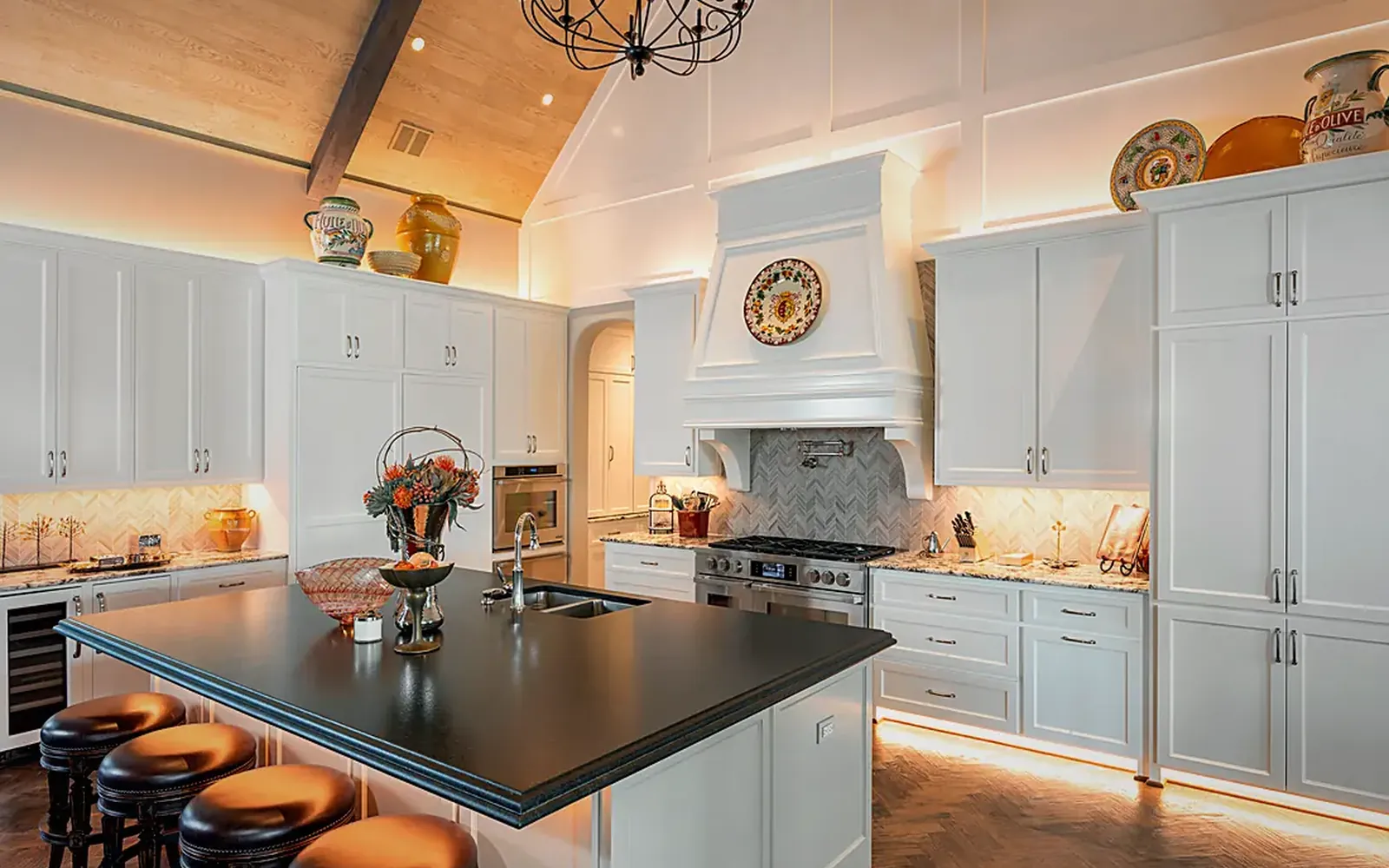 White kitchen with warm LED tape under the upper cabinets and along the toe kick