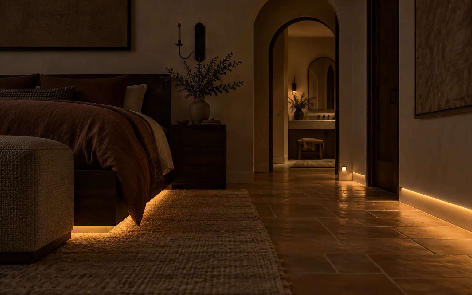 Bedroom at night with a low warm light path along the floor and the shades closed
