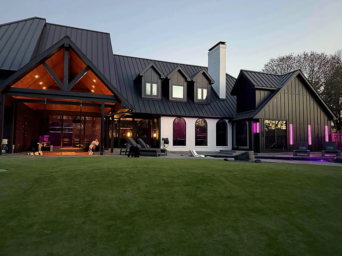 Custom home at dusk with landscape and facade lighting by WH Technologies