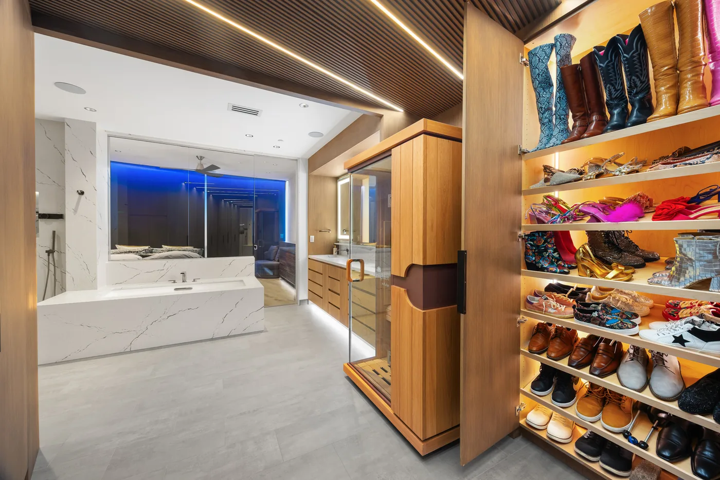 Walk-in closet with lit shoe shelves and a lit slatted ceiling