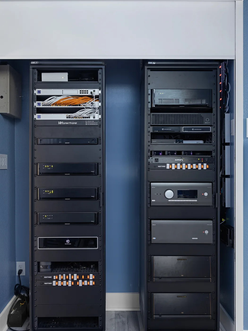Equipment rack with processors, amplifiers and a media server in a dark cabinet