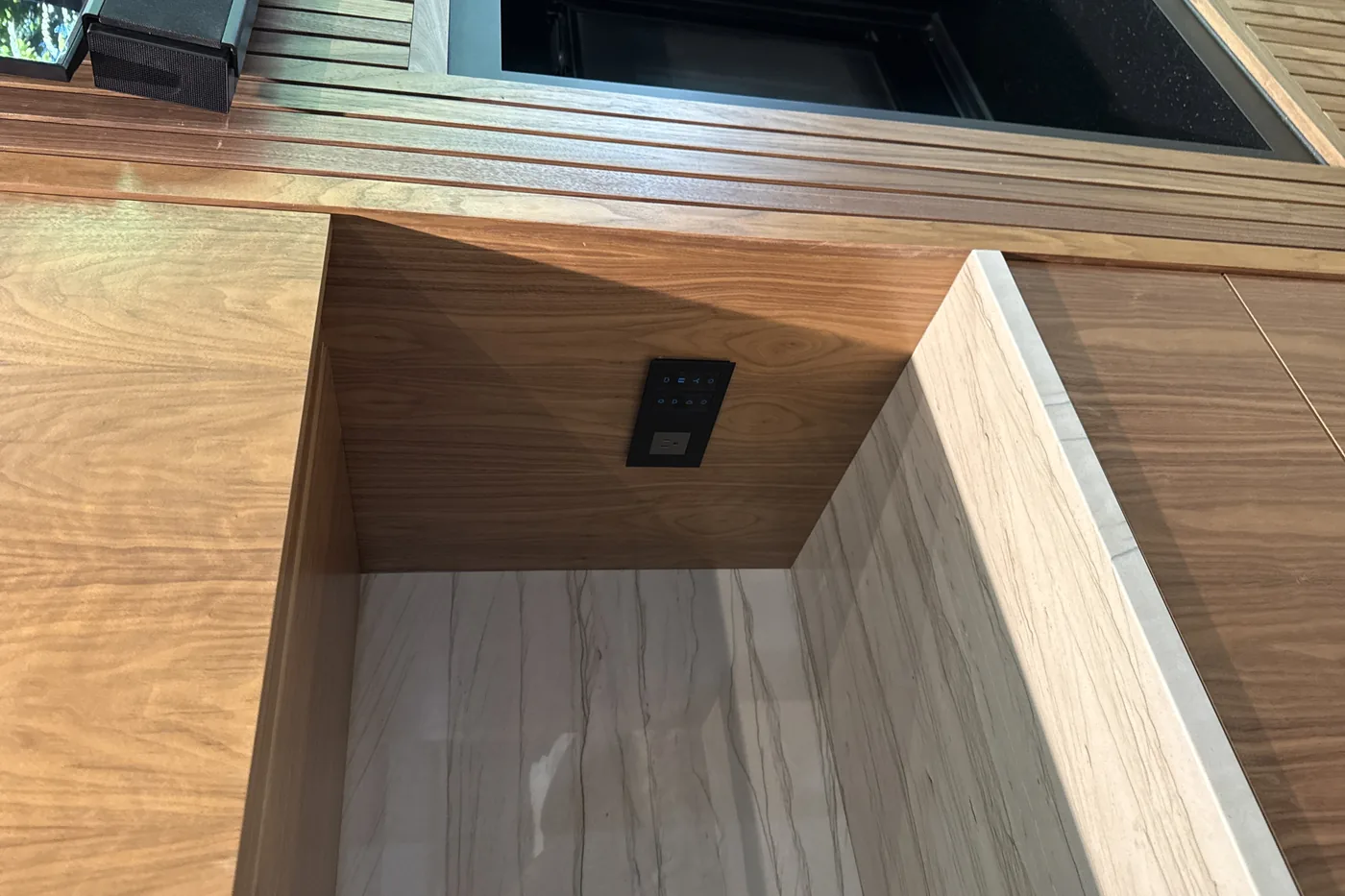 Walnut cabinet with a pocket for a hidden television lift