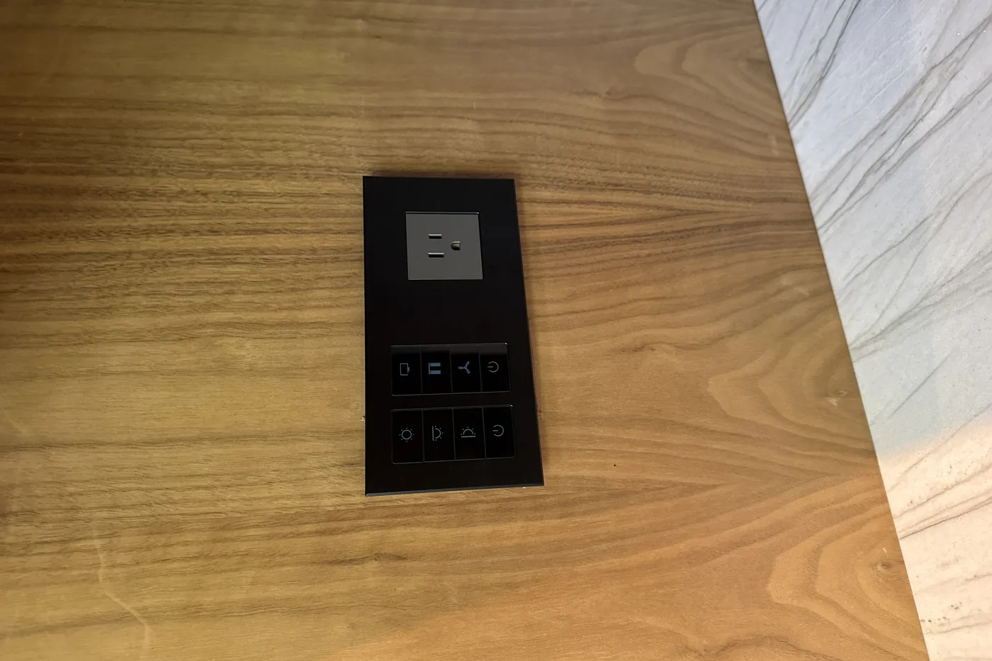 Engraved black keypad set flush into a walnut wall