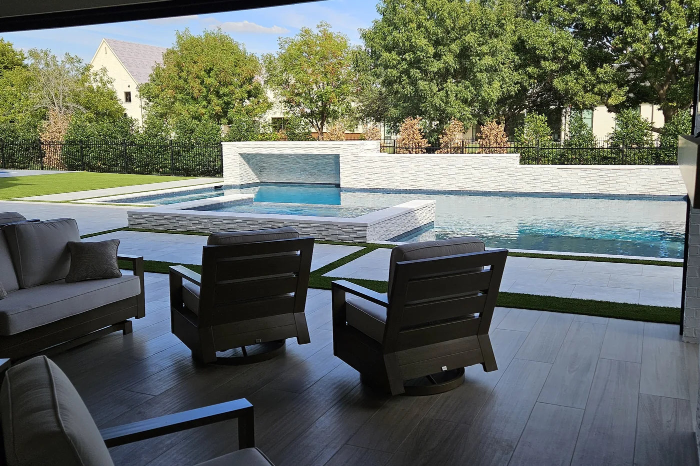 Outdoor lounge seating looking out to the pool and the lawn