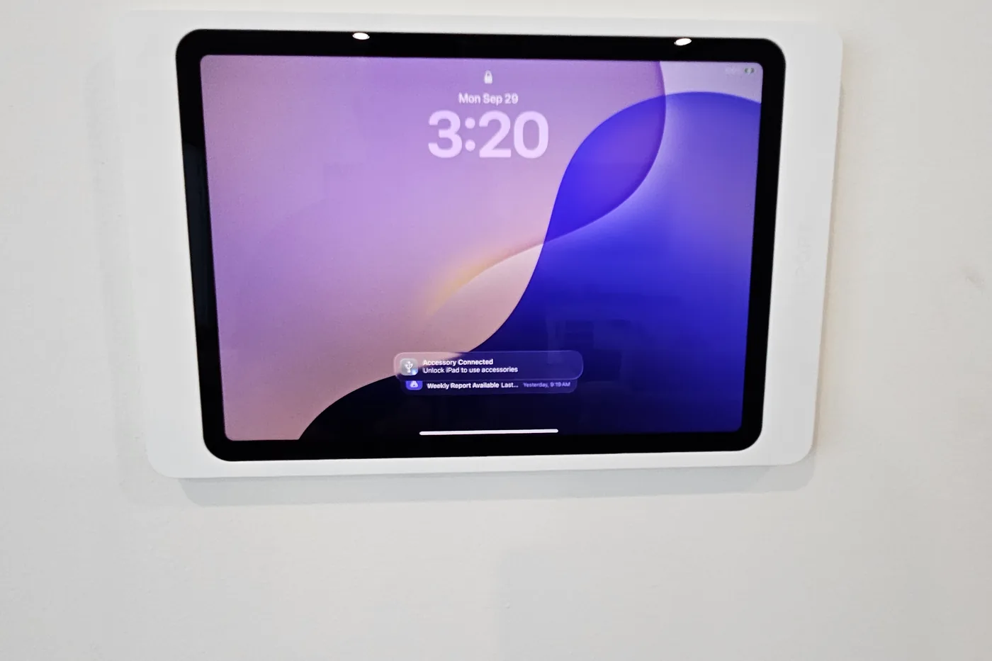 Wall-mounted touch panel beside a doorway